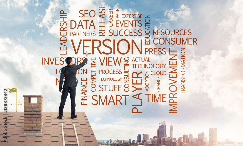 Young businessman standing on house roof and writing leadership 