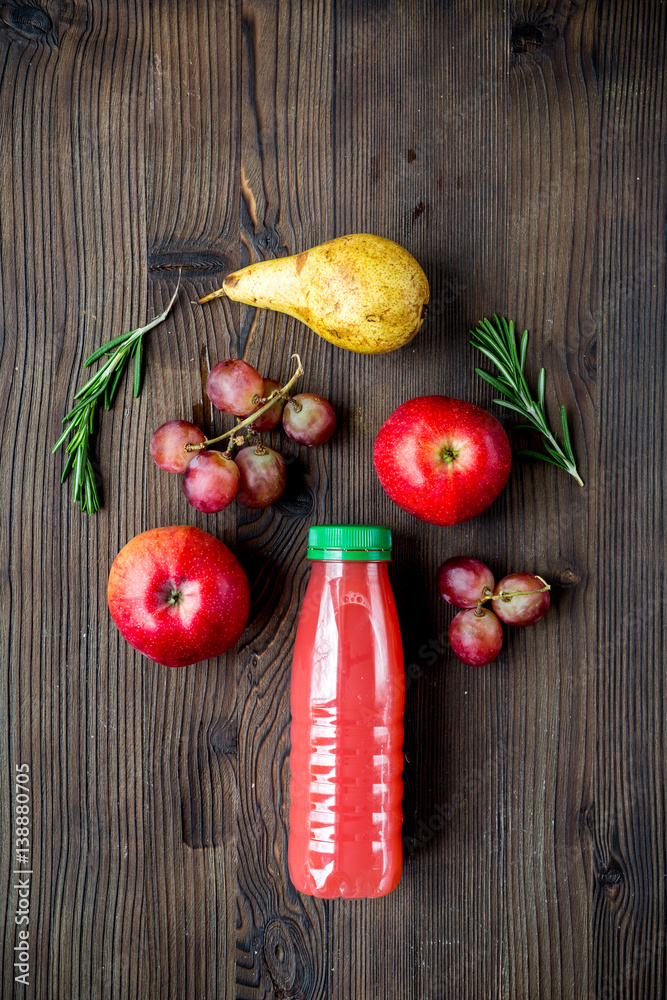 plastic bottles with fruit drinks on wooden background top view mockup