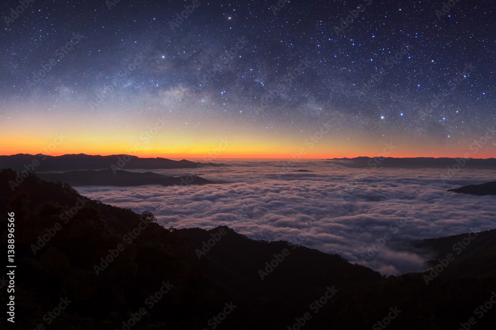 Milky way galaxy over foggy mountains in Thailand. Long exposure photograph.with grain