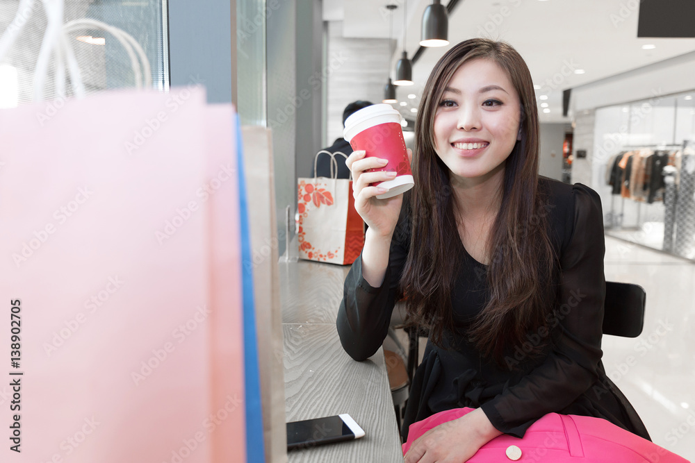 young asian woman shopping in modern shopping mall