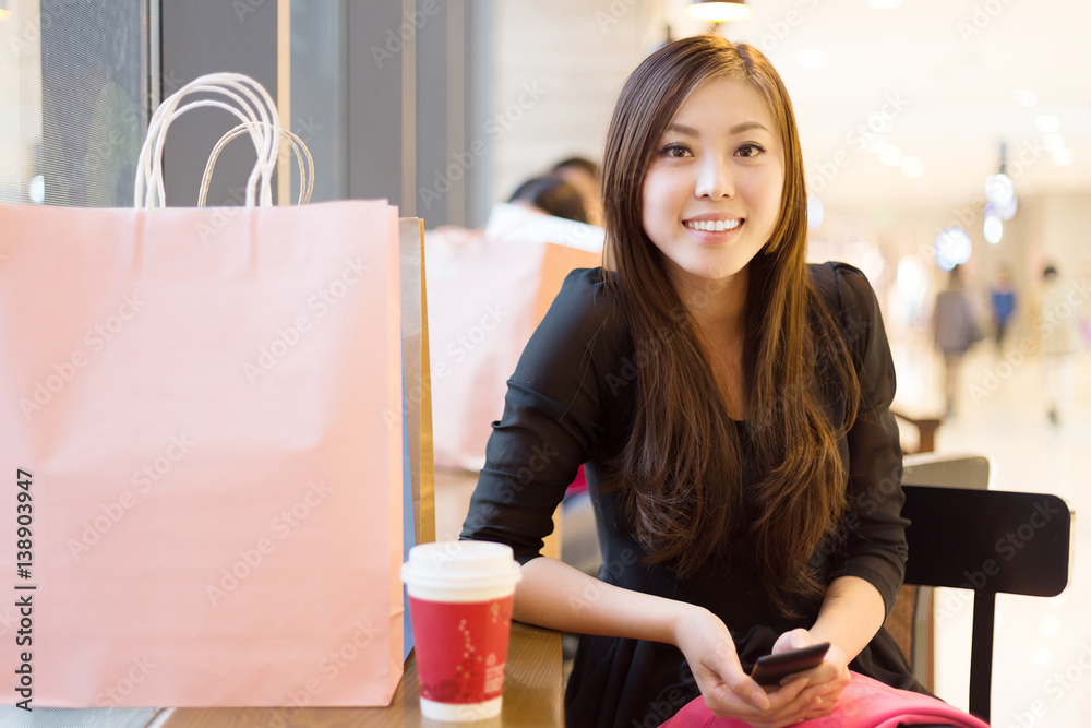 young asian woman shopping in modern shopping mall