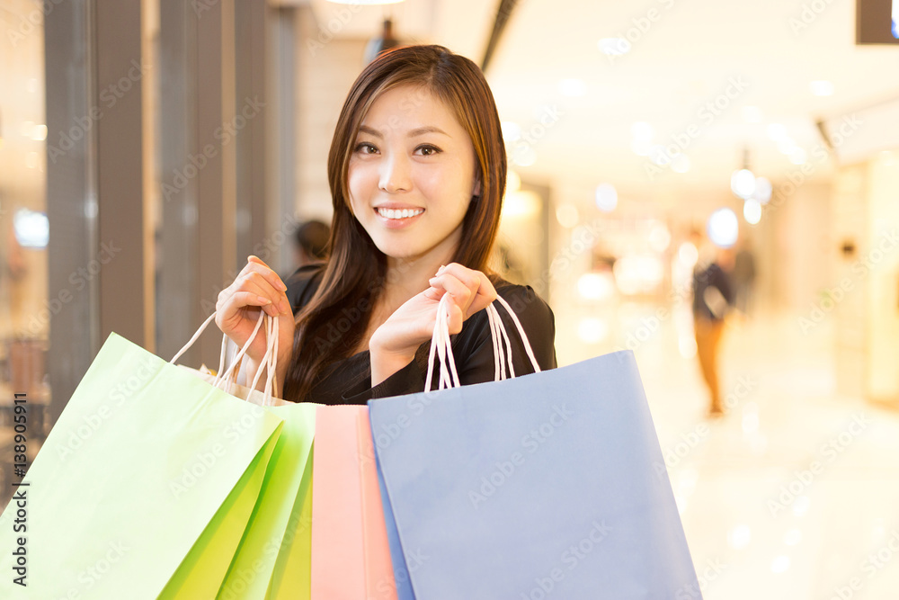 young asian woman shopping in modern shopping mall