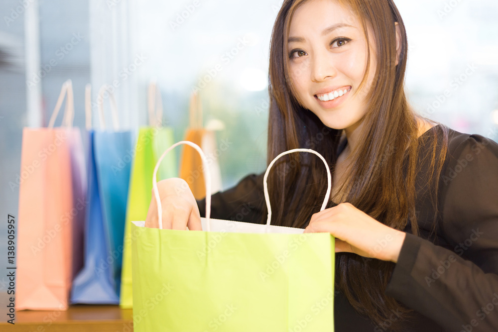 young asian woman shopping in modern shopping mall