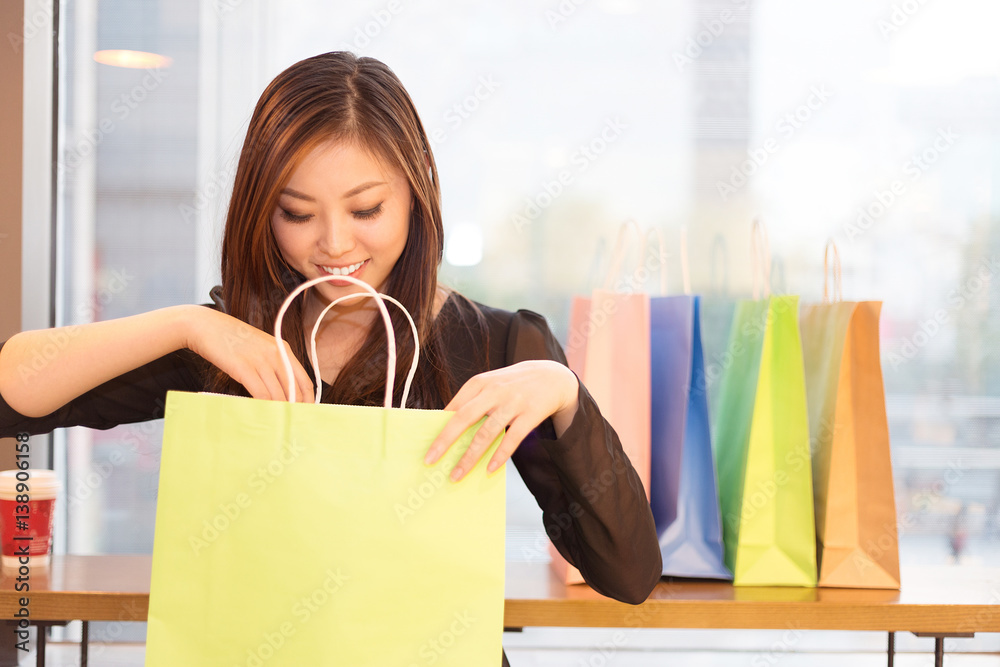 young asian woman shopping in modern shopping mall