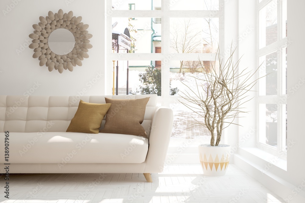 White room with sofa and winter landscape in window. Scandinavian interior design