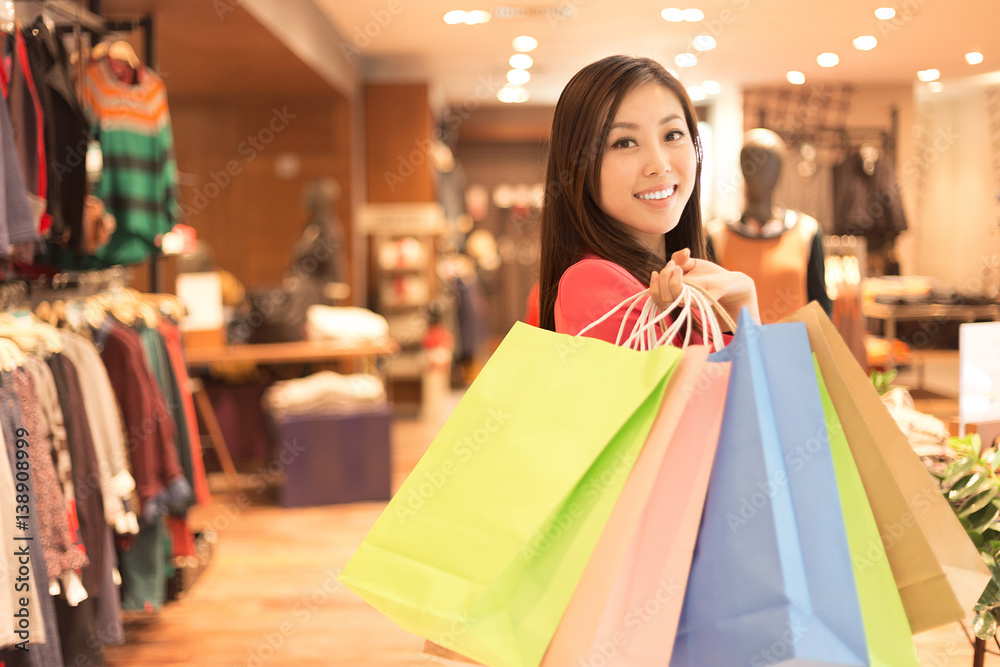 young asian woman shopping in modern shopping mall