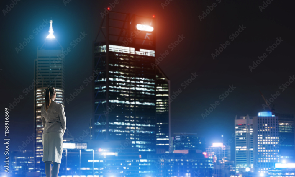 Woman looking at night city