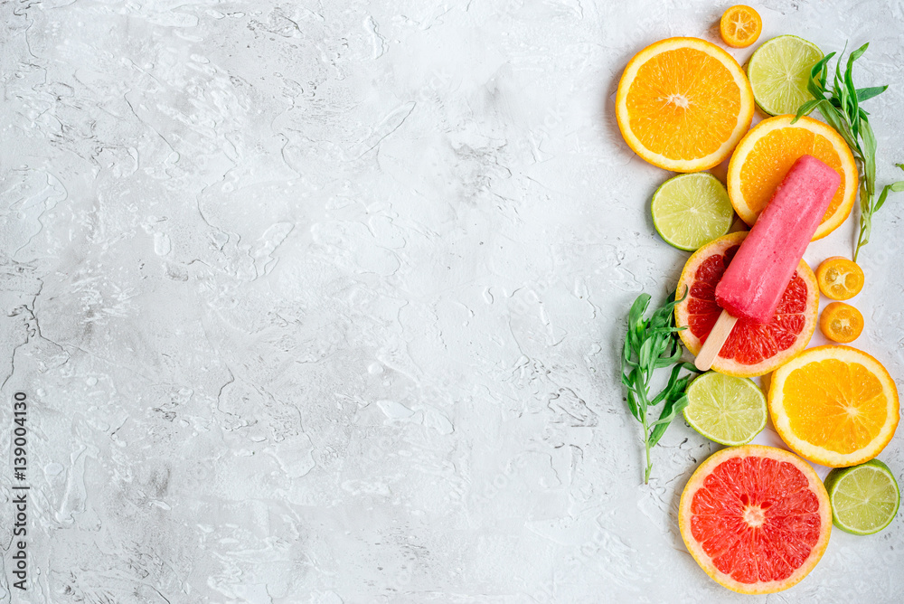 citrus popsicles with fruit slices on stone background top view mockup