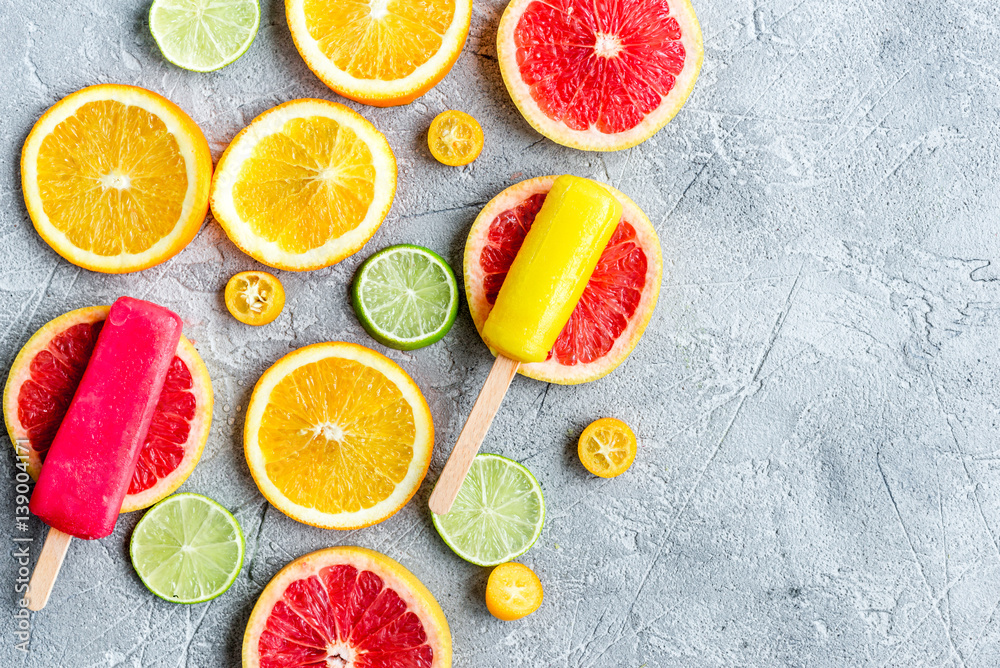 citrus slices with fruit popsicles on table background top view mock up