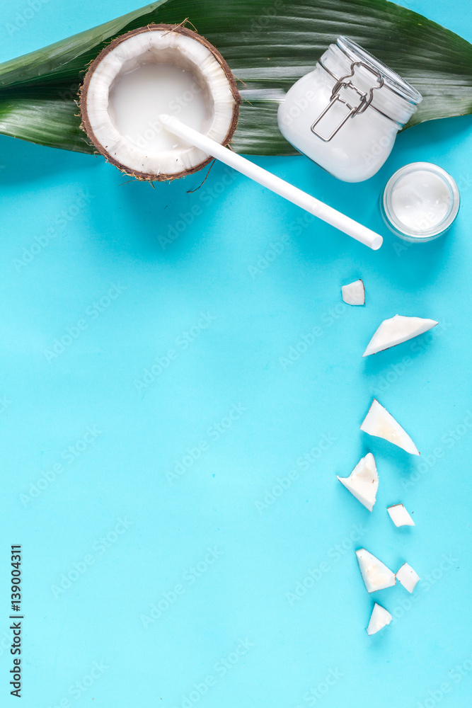 concept organic cosmetics with coconut on blue background top view