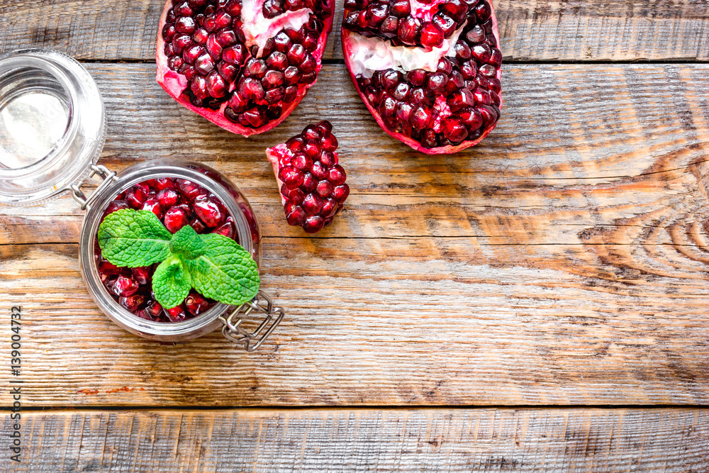 sliced pomegranate on wooden background top view