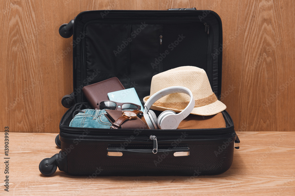 Travel and vacations concept. Open travelers bag with clothing and accessories.