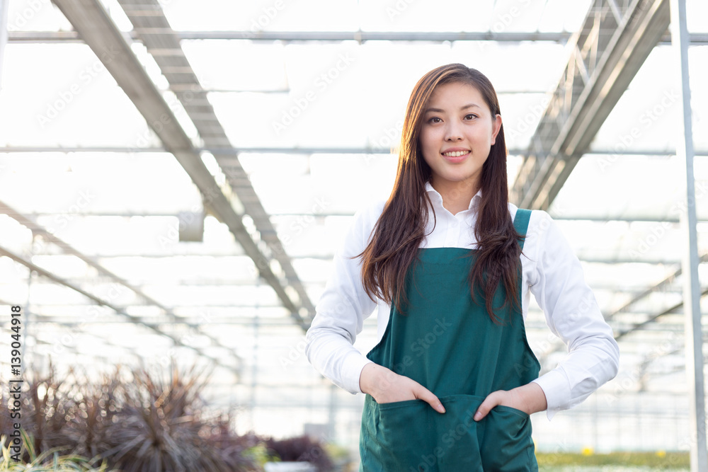 young asian woman works in green house