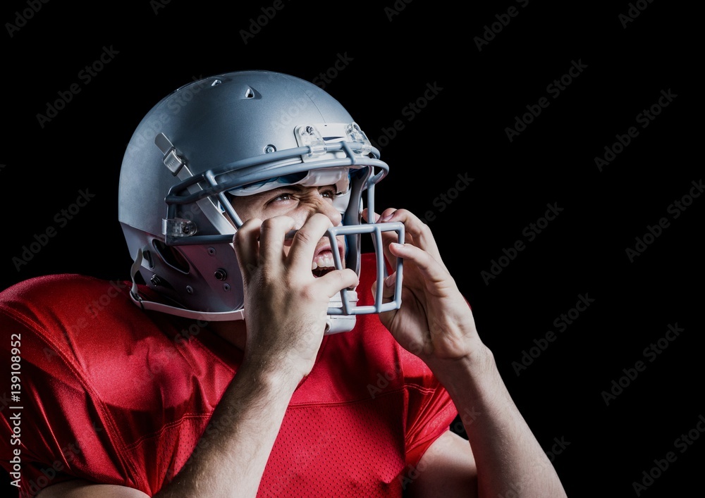 Aggressive american football player holding his helmet 