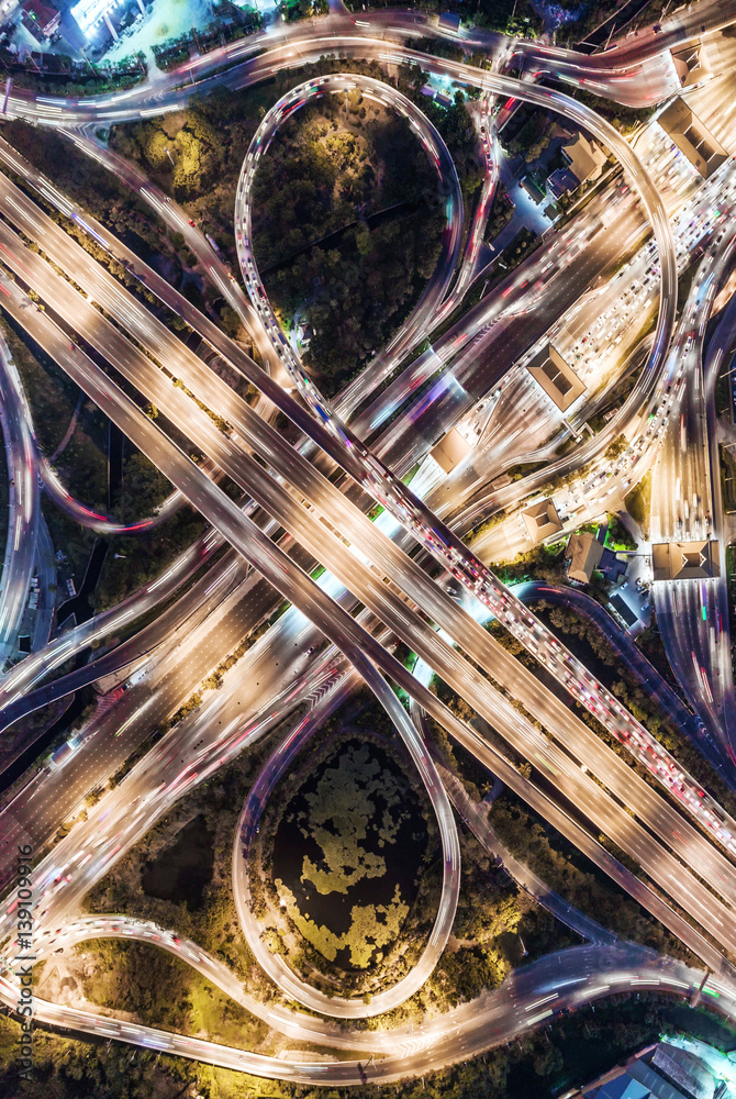 The light on the road  roundabout at night and the city in Bangkok, Thailand. Aerial view, Top view.