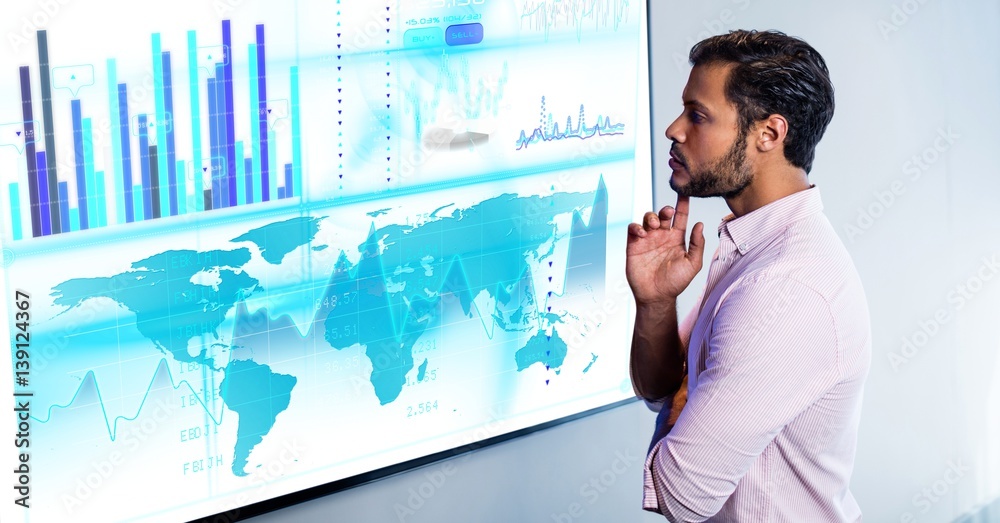 Thoughtful man with finger on chin looking at digital screen