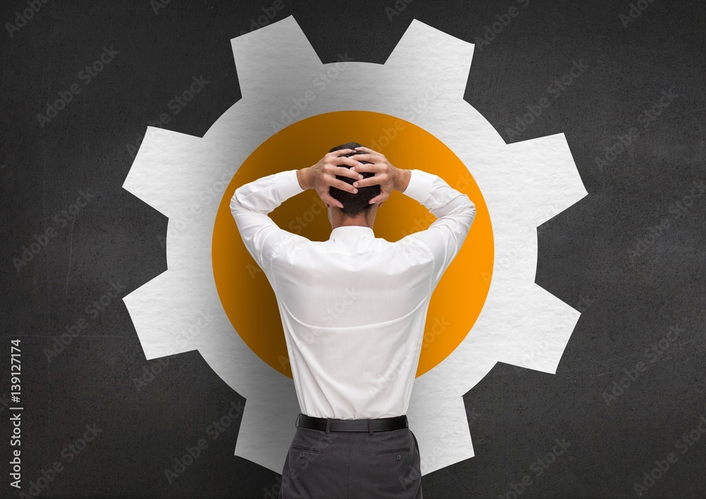 Stressed man standing against setting sign on grey background