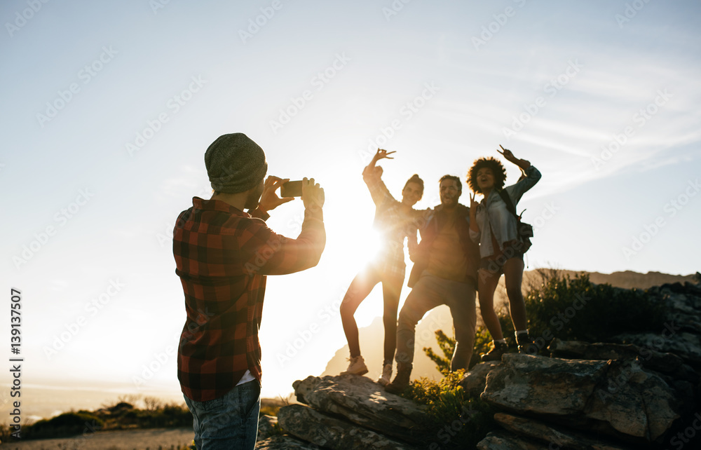 Group of young friends hiking on mountain