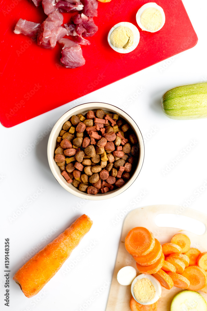 healthy dogfood with eggs, vegetables and meat on kitchen background top view