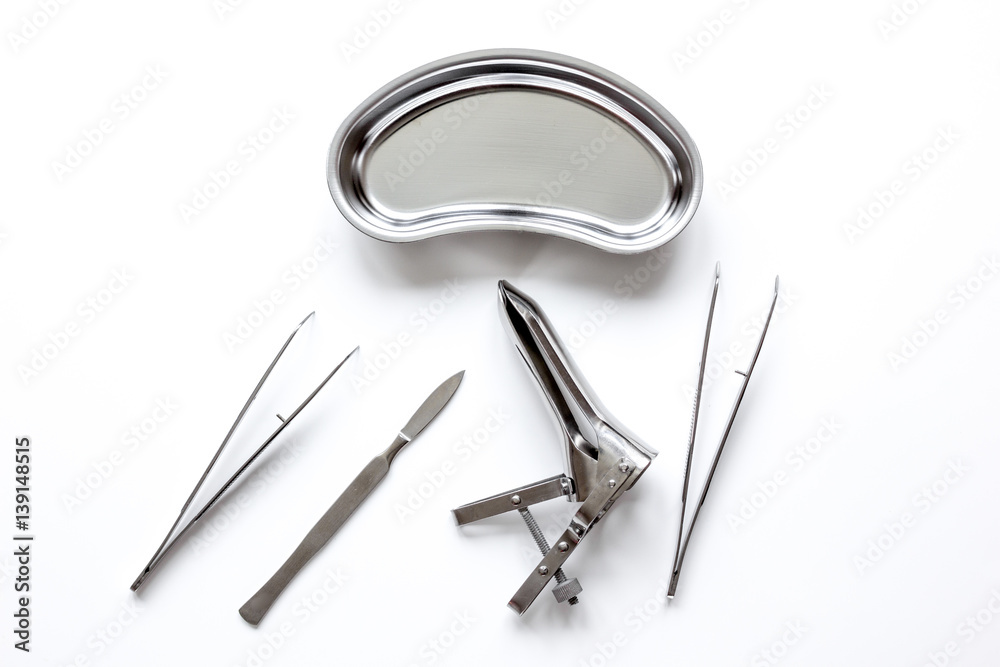 instruments of gynecologist on white background top view