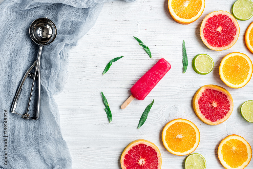 citrus slices with fruit popsicles on table background top view