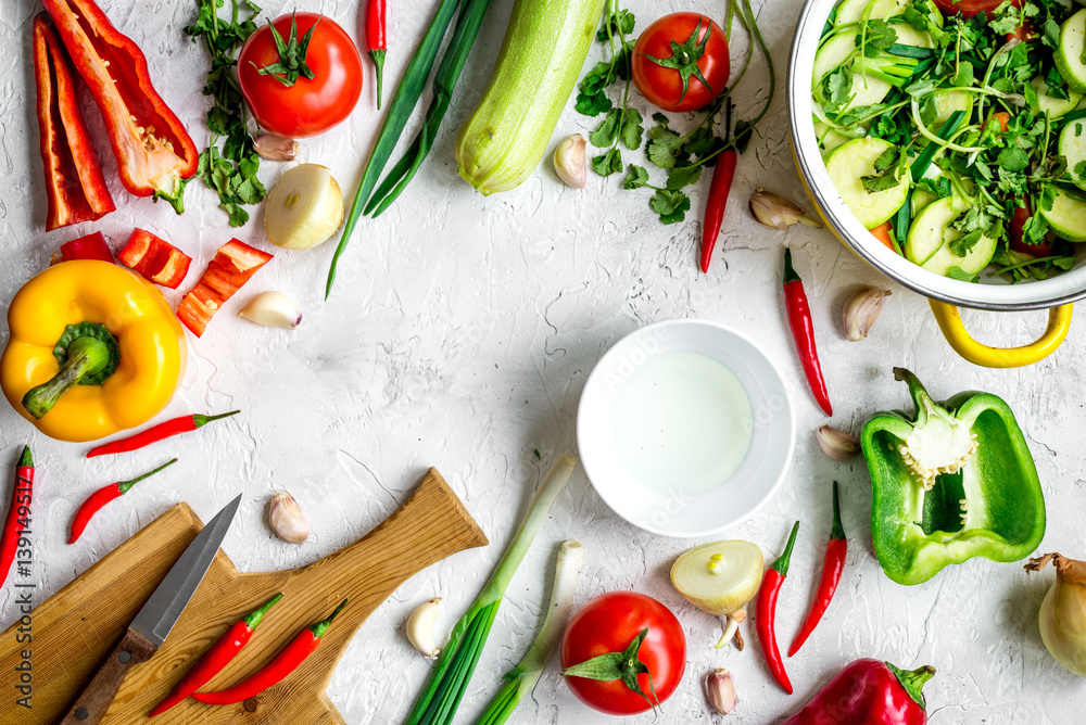 cooking vegetables on the stone background top view