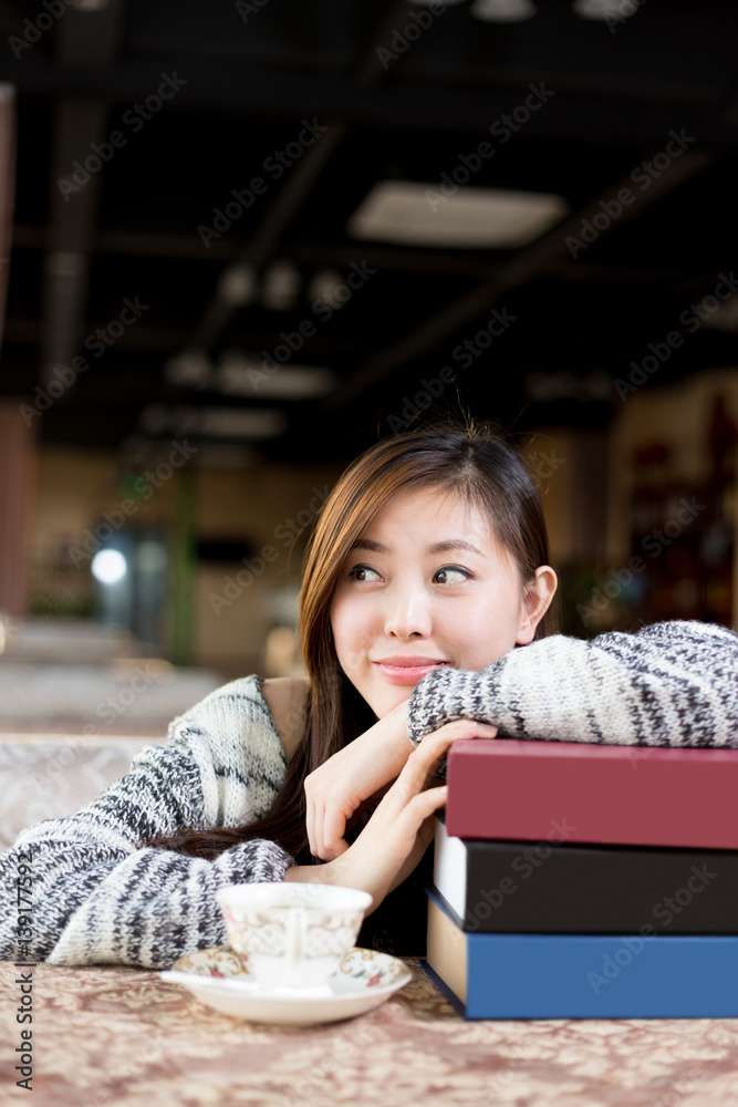 young pretty woman sits in cafe