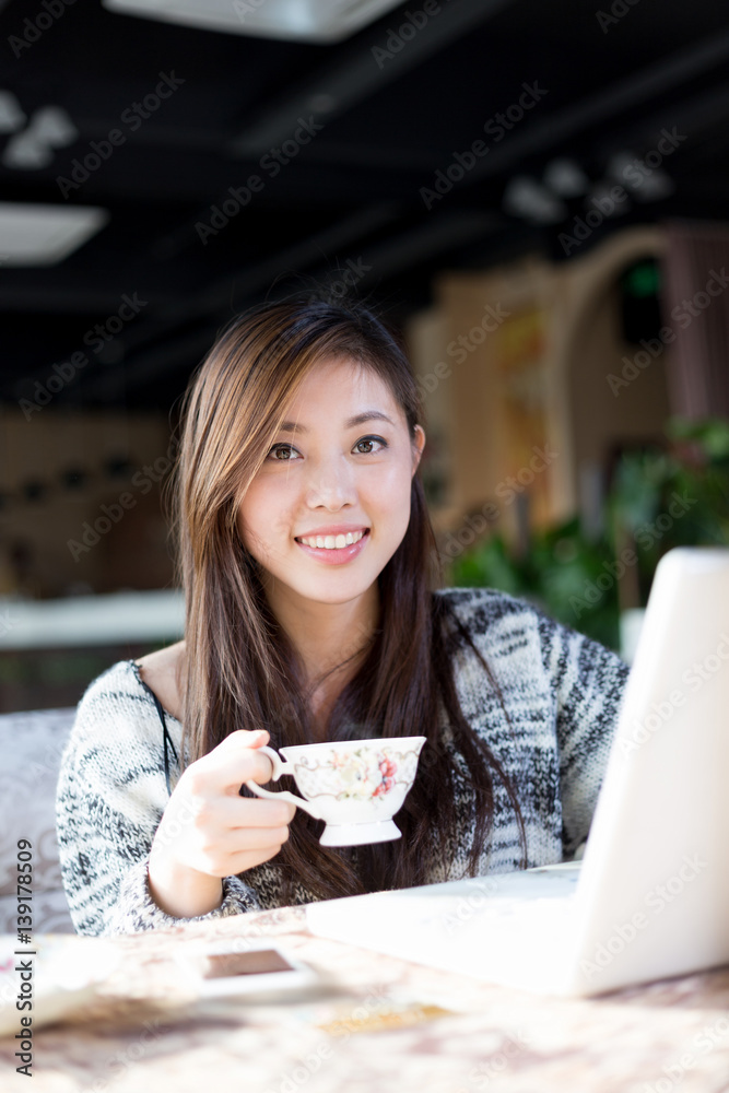 young pretty woman sits in cafe