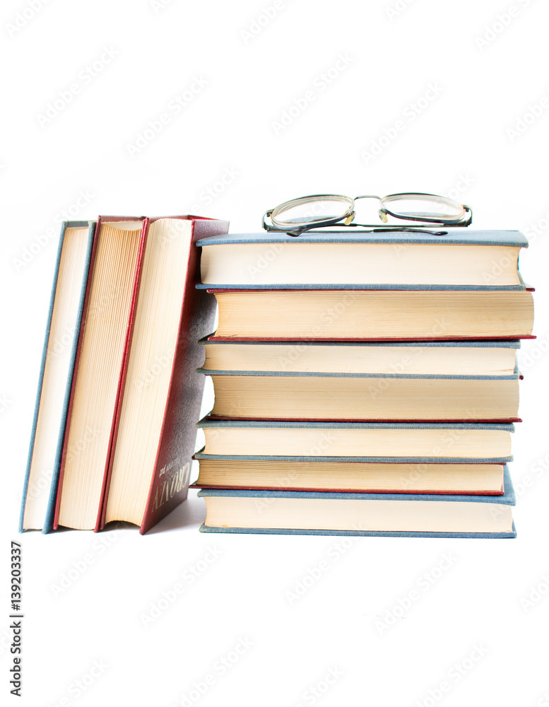 pile of old books stacked on top of each other isolated