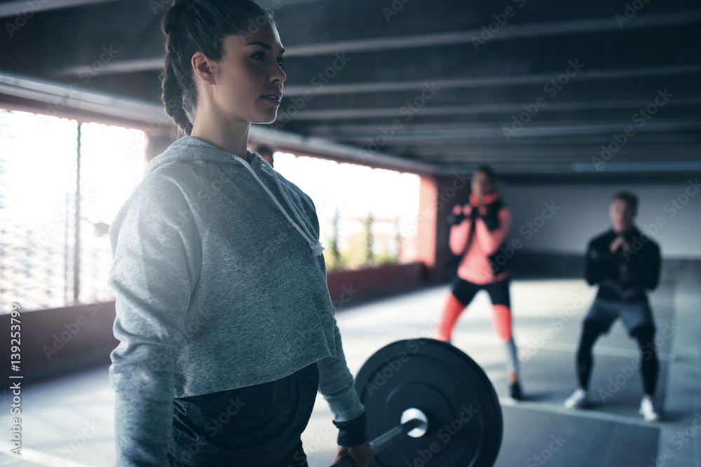 Sporty girl weightlifting.