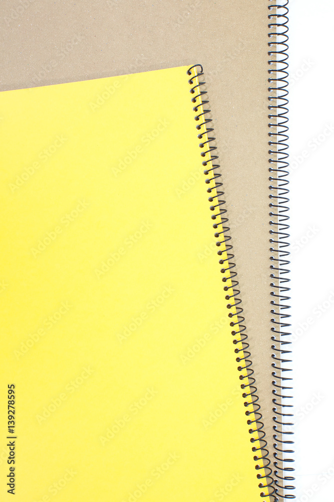 Yellow note book cover and brown note book on white background