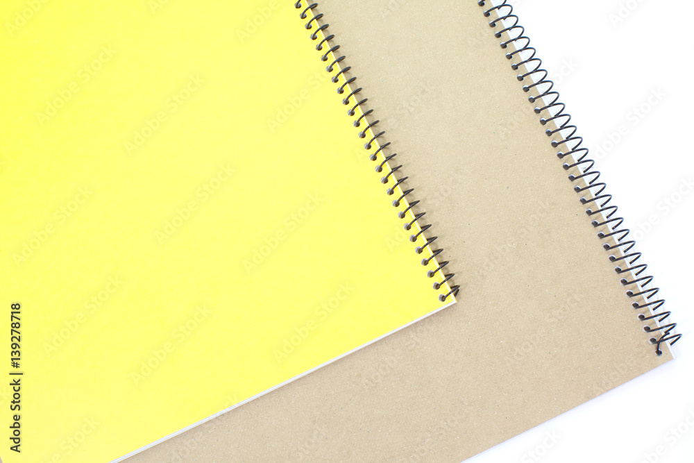 Yellow note book cover and brown note book on white background