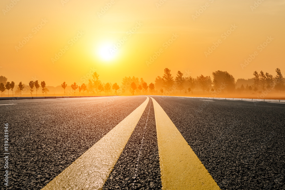 Asphalt road and sky at sunset