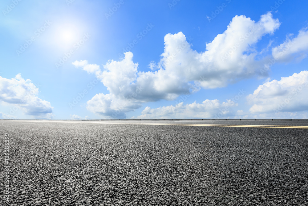 asphalt road under the blue sky