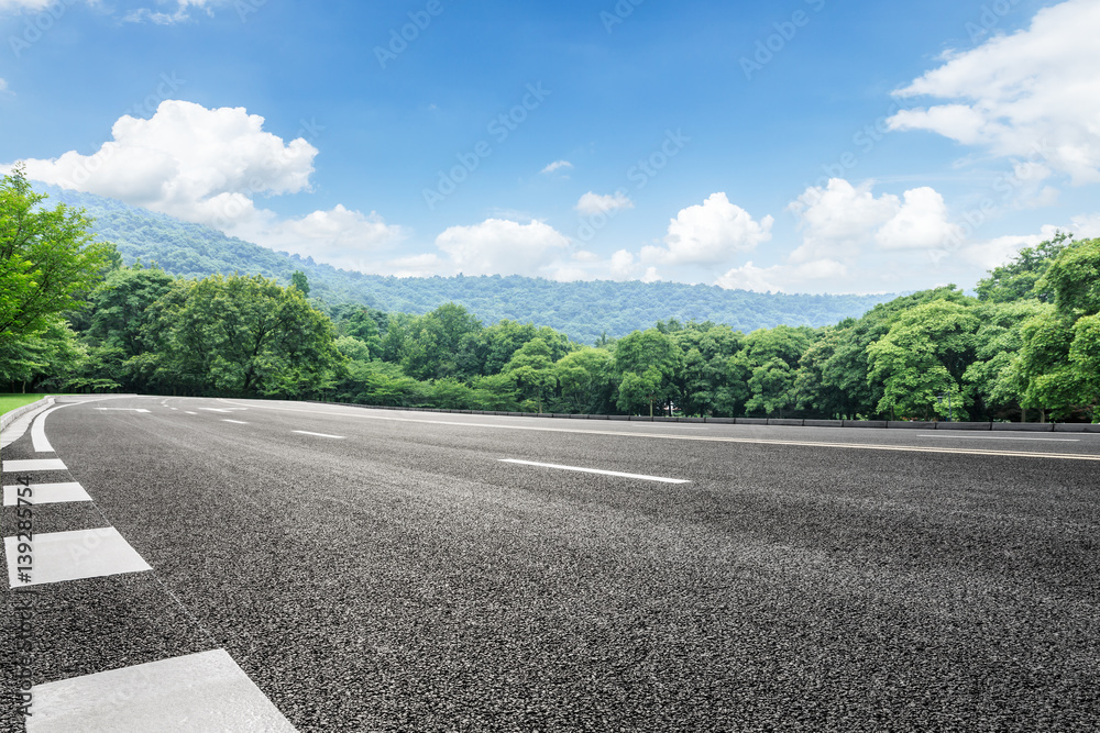 Asphalt highways and mountains under the blue sky