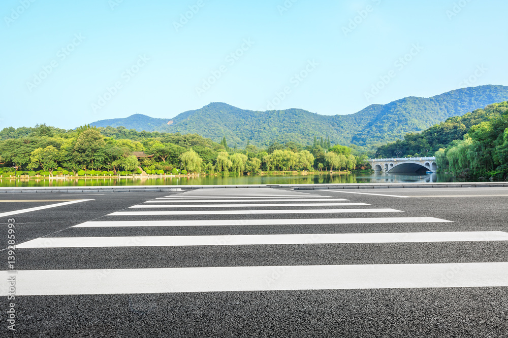 asphalt road and mountains under the blue sky