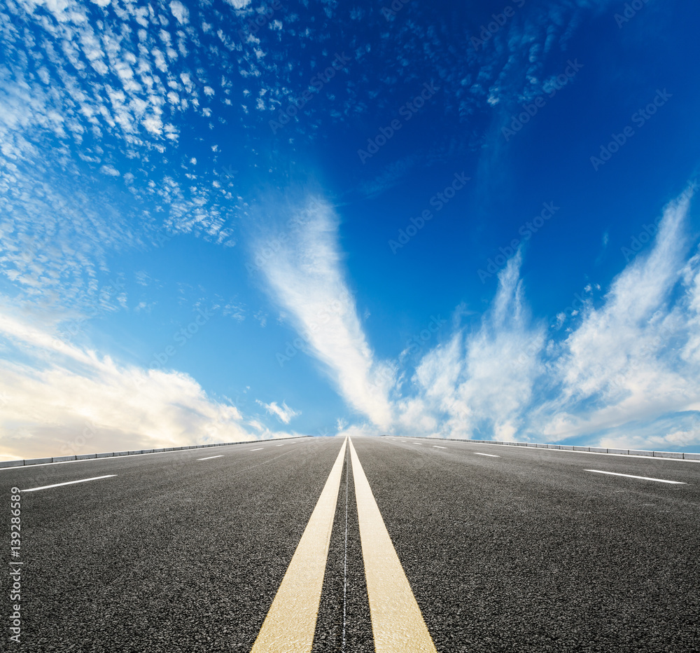 asphalt road under the blue sky