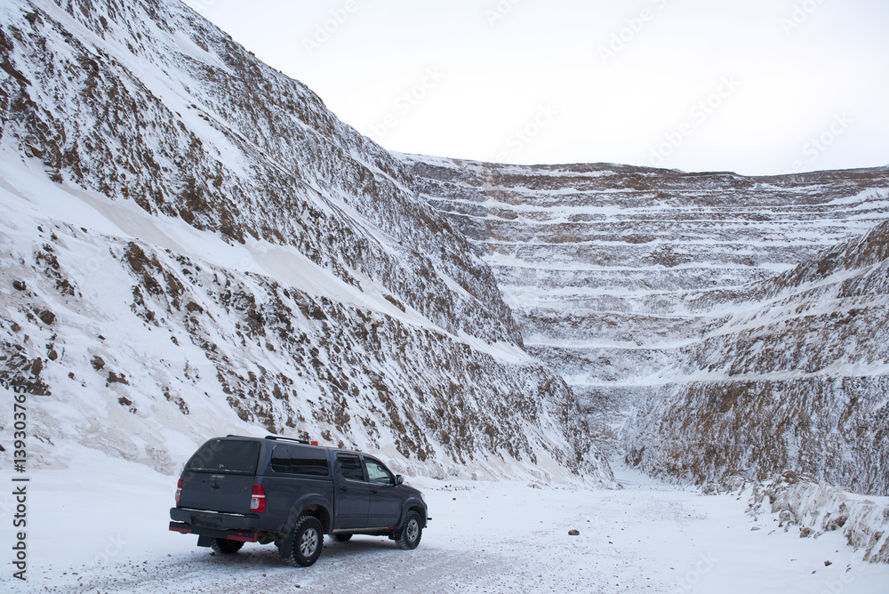 Car wirh worker at an open pit