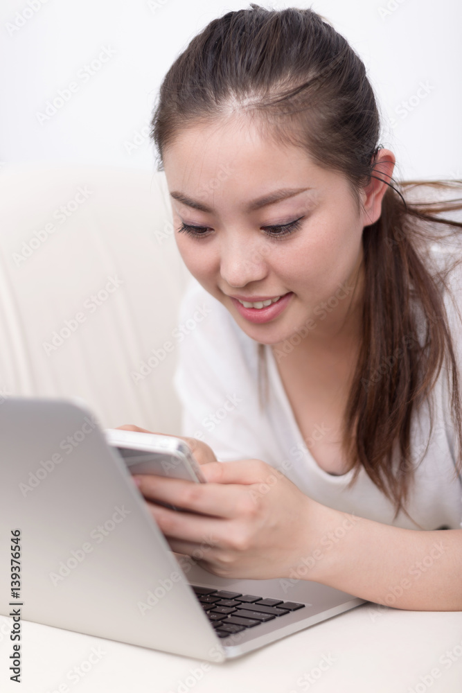 young pretty woman using laptop on bed