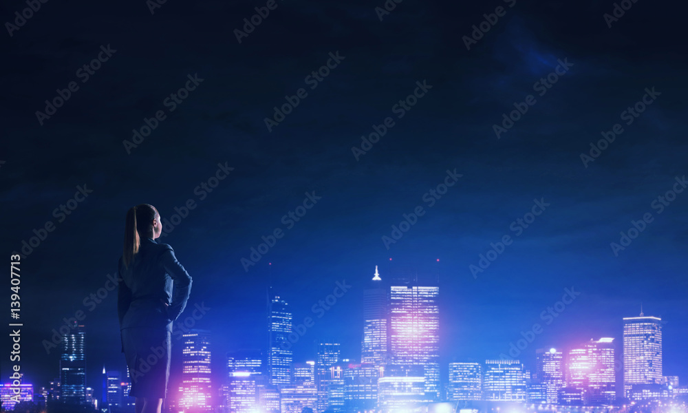 Woman looking at night city