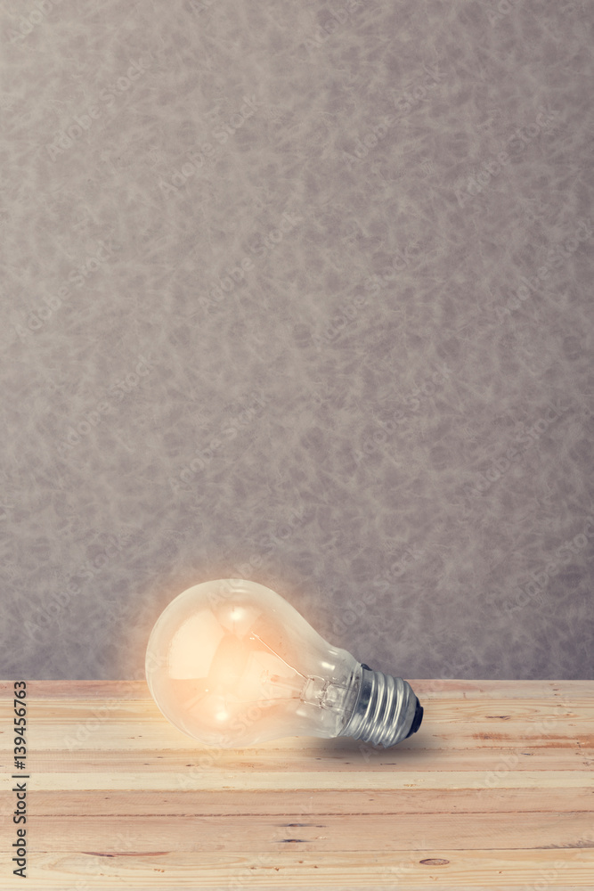 glowing bulb on wooden floor