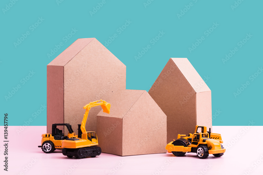 house construction business ideas concept with house cardboard paper and toy car with free copyspace