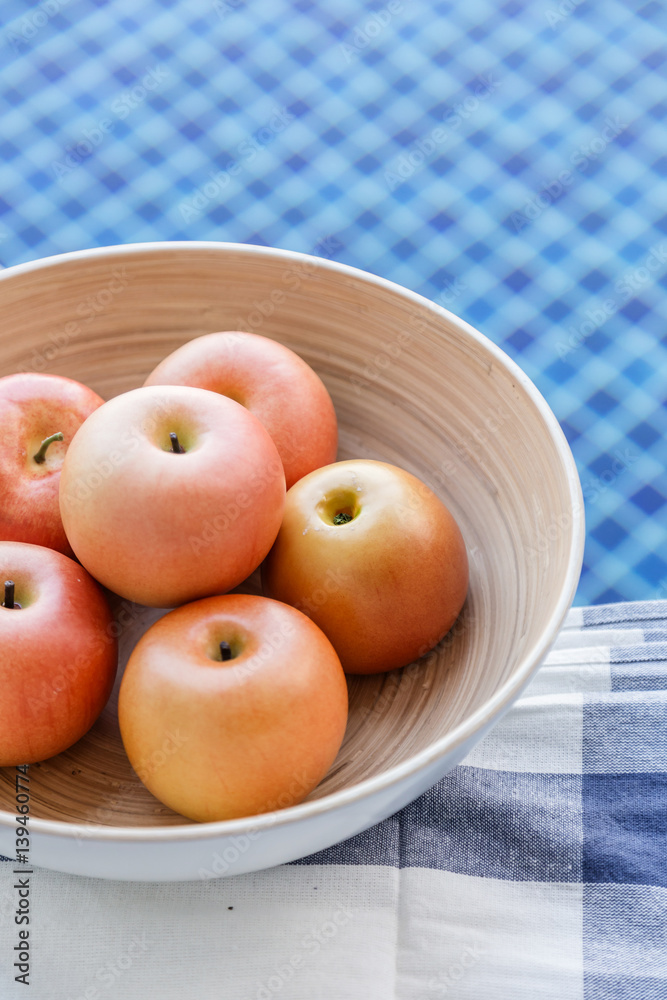 fresh apple in wooden bowl near swiming pool relax and healthy ideas comcept with free copyspace for