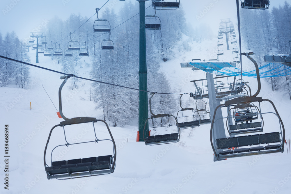 Aerial ropeway with empty chairlifts at ski resort