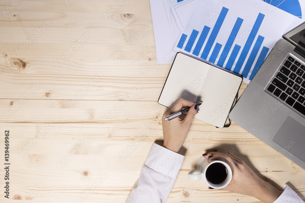 Business woman in an office holding coffe - bird perspective