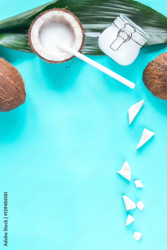 concept organic cosmetics with coconut on blue background top view