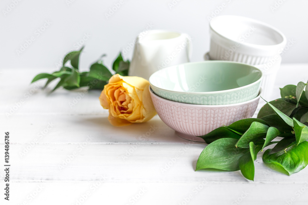 ceramic tableware with flowers on white background