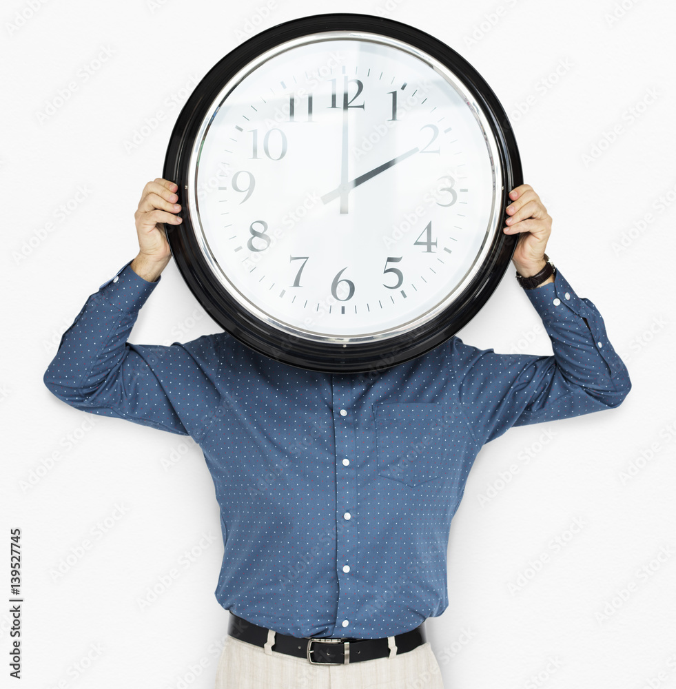 Man Holding Clock Covering Face