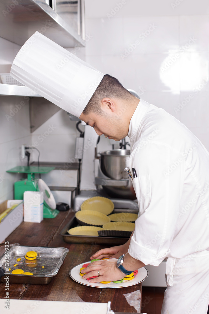 young man chelf makes food in kitchen