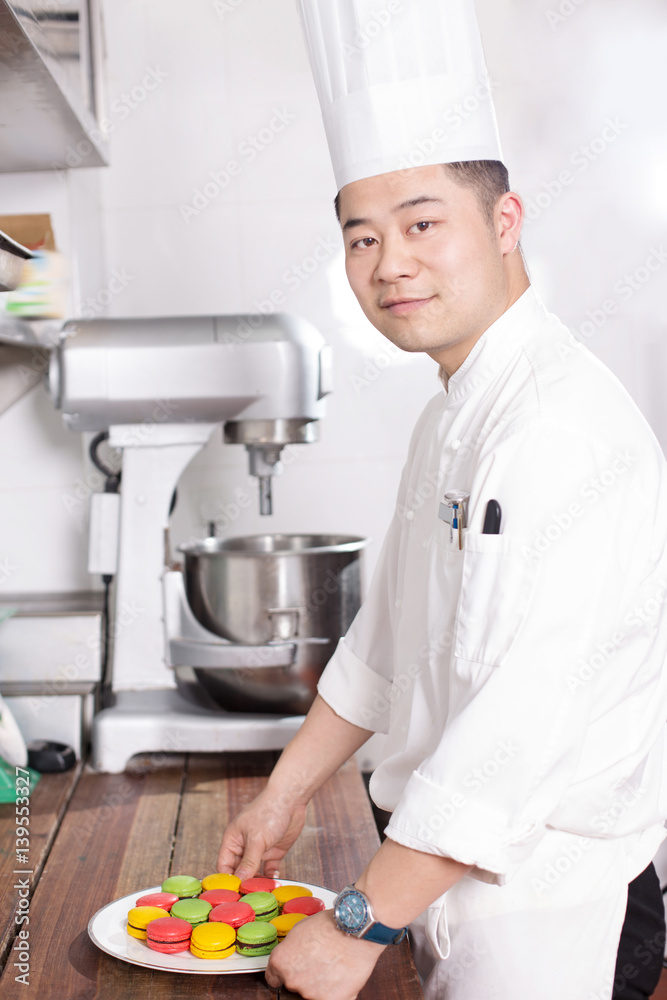 young man chelf makes food in kitchen